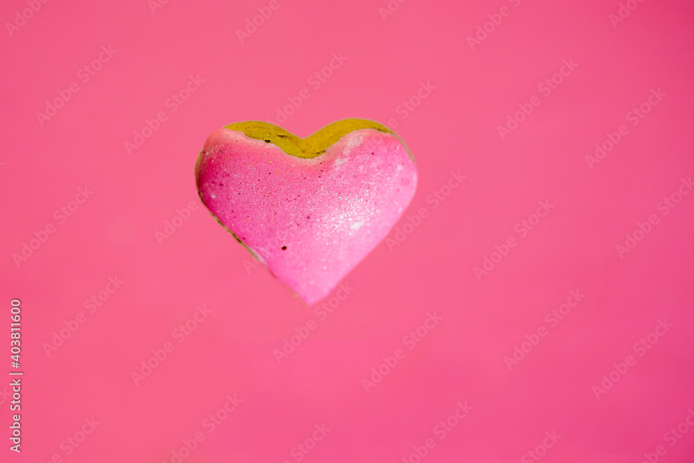 Heart-shaped biscuit. Pink background. Valentines day.