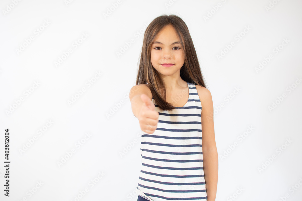 Beautiful smiling little girl in striped t-shirt showing thumb up over white background. Beautiful smiling little girl in striped t-shirt showing thumb up over white background.