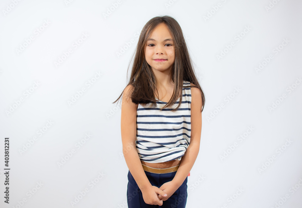 Beautiful little girl in striped t-shirt smiling over white background. Beautiful little girl in striped t-shirt smiling over white background.