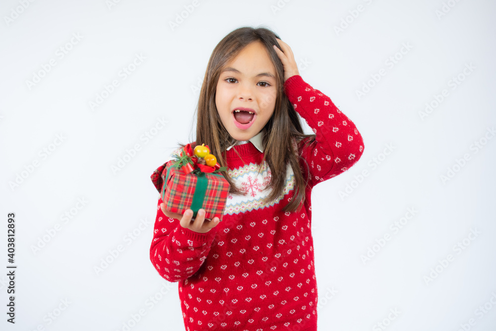 Joyful little girl holding gift box in hands over white background. Joyful little girl holding gift box in hands over white background.