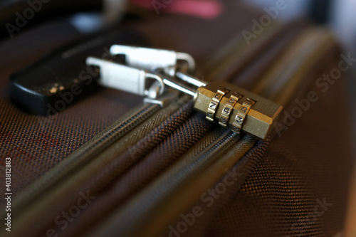 Closeup of a security combination padlock on luggage. Soft focus image.