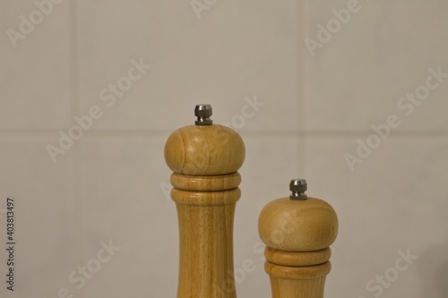 A wooden pepper mill and salt mill isolated in the kitchen (Pesaro, Marche, Italy)