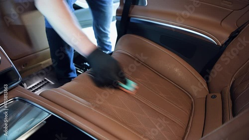 Detailing and cleaning of back seats at luxury modern car. Car interior washing.
