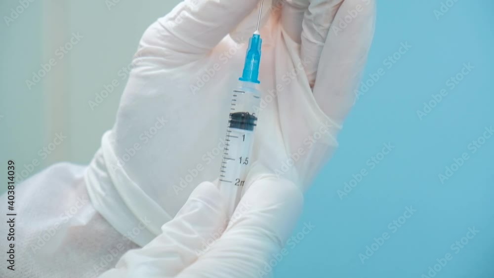 Vaccine against coronavirus. Doctor prepares an injection with the coronavirus vaccine to the patient. Vaccination of the population against coronavirus infection. Vaccine against coronavirus. Doctor prepares an injection with the coronavirus vaccine to the patient. Vaccination of the population against coronavirus infection.
