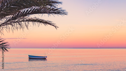 sunset over the ocean, boat, palm tree