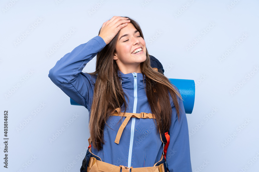 Teenager hiker girl over isolated background laughing Teenager hiker girl over isolated background laughing
