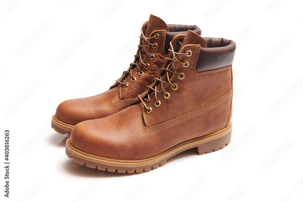 Mens leather brown waterproof boots for winter or autumn hiking isolated on white background. Mens fashion, trendy footwear. Close up view. Mens leather brown waterproof boots for winter or autumn hiking isolated on white background. Mens fashion, trendy footwear. Close up view.