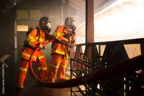 Firefighters spraying water on fire