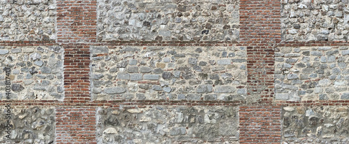Background of a old brick and stone wall. Seamless texture. Perfect tiled on all sides.