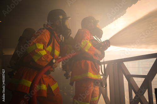 Firefighters spraying water on fire