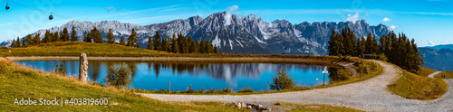 High resolution stitched panorama of a beautiful alpine summer view with reflections in a lake at the famous Hartkaiser summit, Ellmau, Wilder Kaiser, Tyrol, Austria photo