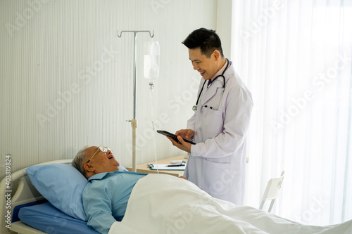 Asian medical doctor with old patient on the bed in hospital 
