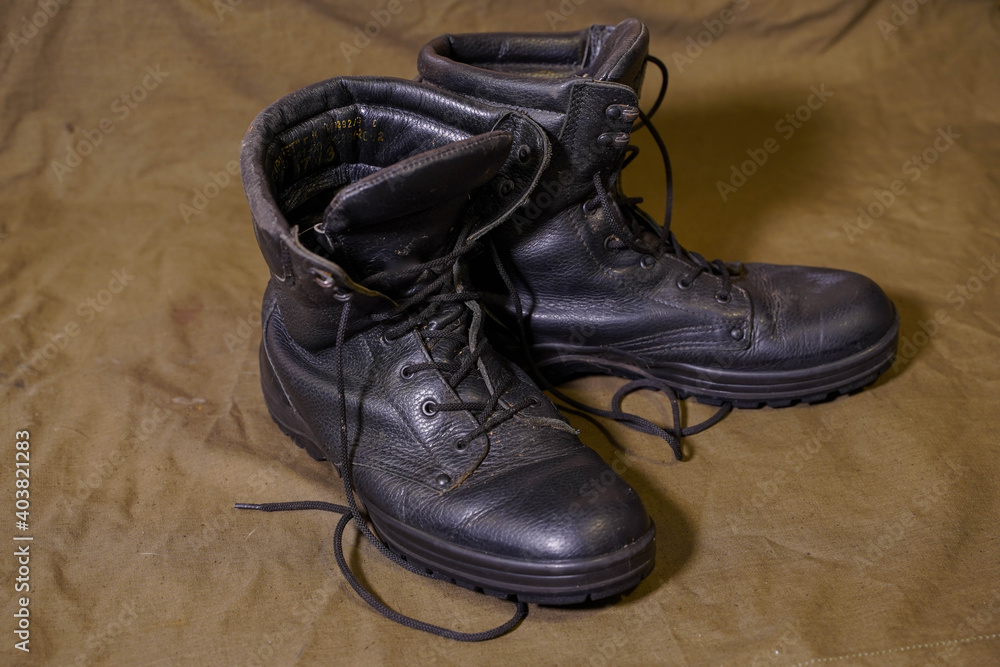 Black combat boots on army cloth
Black combat boots on army cloth