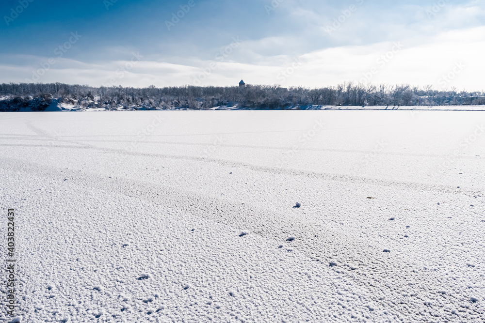 Spacious snow landscape. River and hills in Russia, white winter on the terrain, a lot of fluffy snow and ice