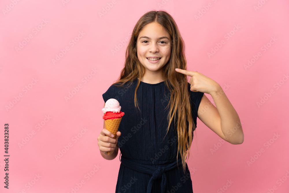 Child with a cornet ice cream over isolated pink background giving a thumbs up gesture Child with a cornet ice cream over isolated pink background giving a thumbs up gesture