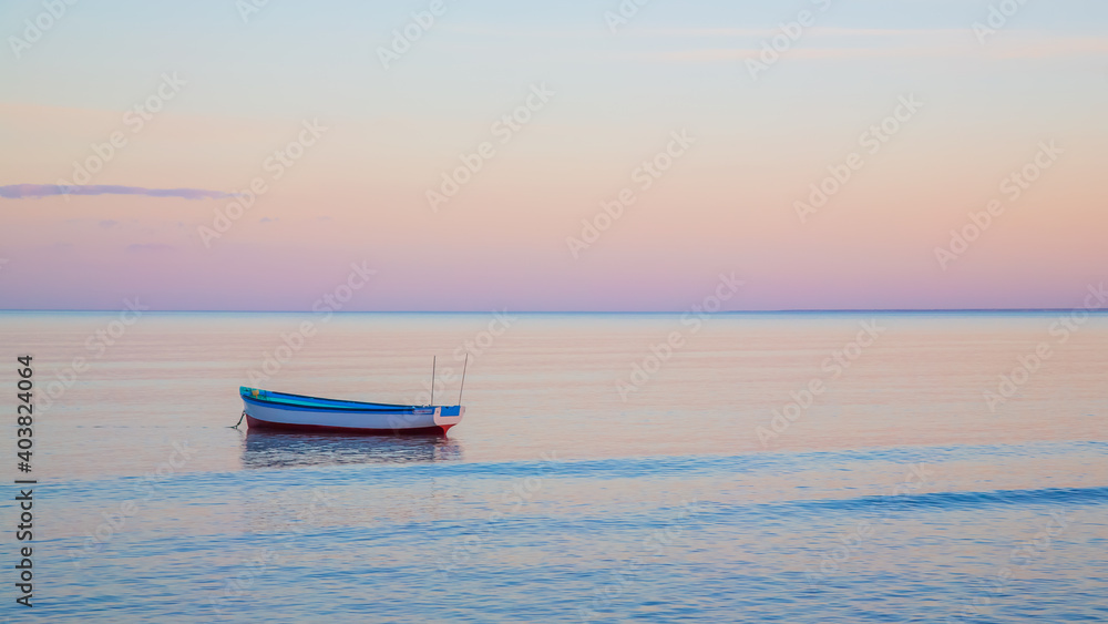 boat on calm ocean at sunset, background