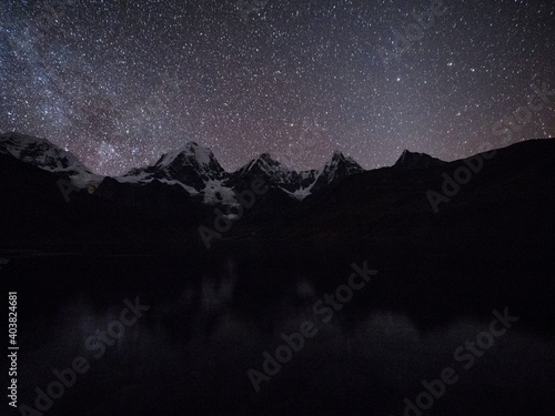 Night sky milky way stars at Cordillera Huayhuash Circuit andes alpine mountain lake Laguna Carhuacocha Ancash Peru photo