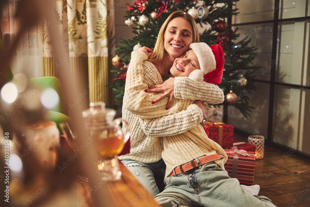 Happy family hugging during Christmas celebration at home