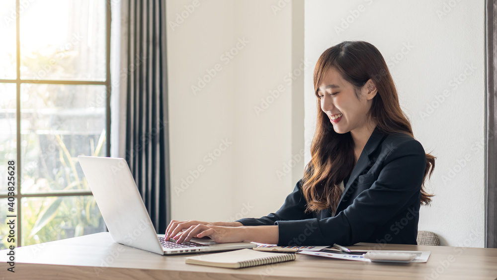 The smart, cute, charming, elegant businesswoman meets online with international business partners, she sits at a table at the workstation.