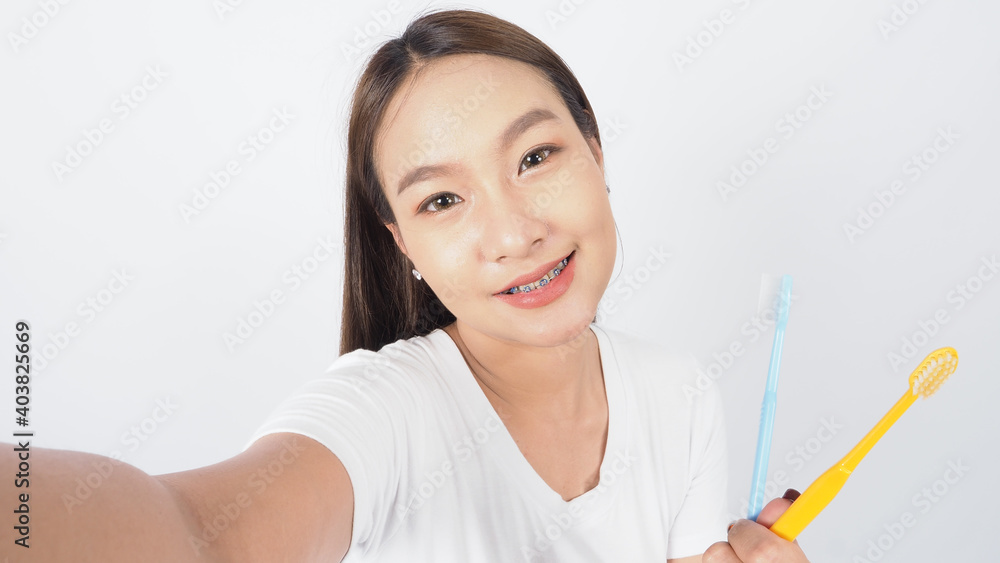 Braces teeth. Dental brace sexy girl smile holding toothbrush and looking to camera. white teeth with blue braces. Dental care. Asian woman with contact lens and orthodontic. Dental care concept. Braces teeth. Dental brace sexy girl smile holding toothbrush and looking to camera. white teeth with blue braces. Dental care. Asian woman with contact lens and orthodontic. Dental care concept.