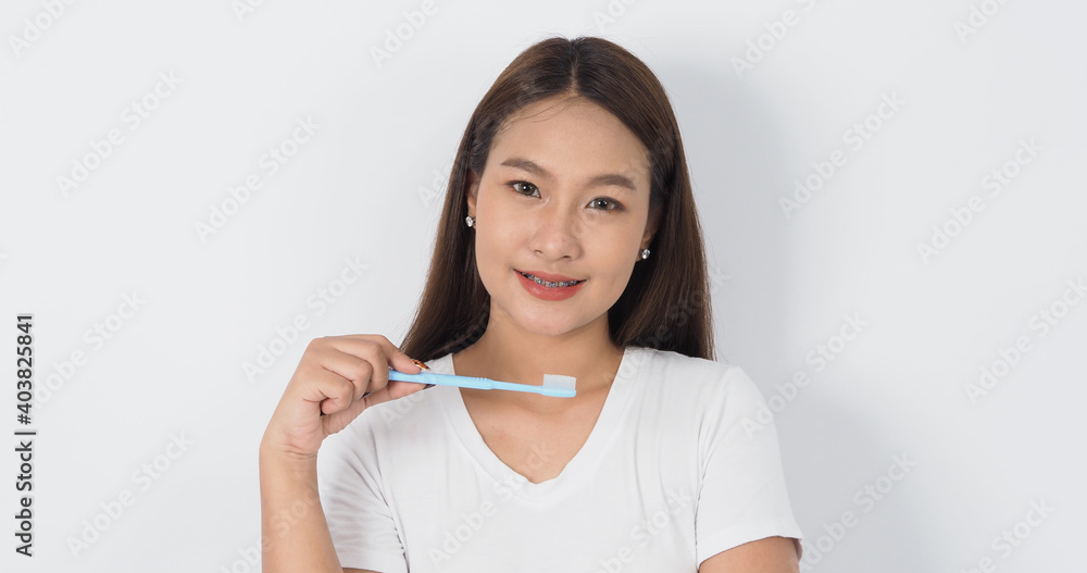 Braces teeth. Dental brace sexy girl smile holding toothbrush and looking to camera. white teeth with blue braces. Dental care. Asian woman with contact lens and orthodontic. Dental care concept. Braces teeth. Dental brace sexy girl smile holding toothbrush and looking to camera. white teeth with blue braces. Dental care. Asian woman with contact lens and orthodontic. Dental care concept.