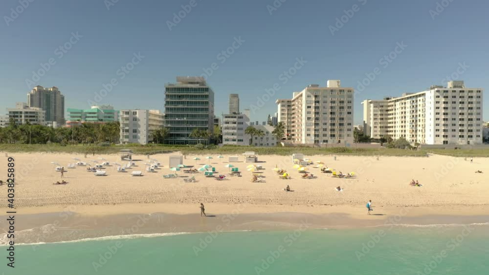 Aerial tracking shot woman walking on the seashore Aerial tracking shot woman walking on the seashore