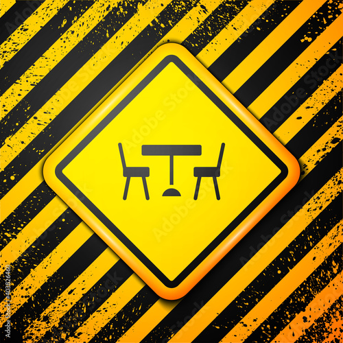 Black Picnic table with chairs on either side of the table icon isolated on yellow background. Warning sign. Vector.