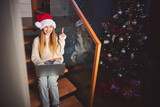 Cheerful cute girl using laptop at Christmas