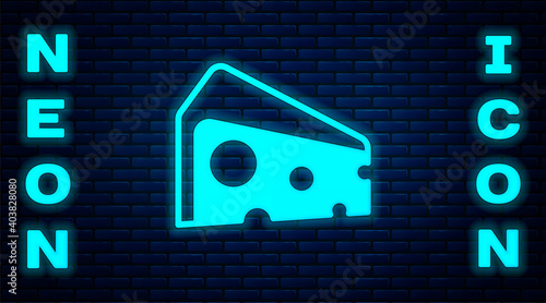 Glowing neon Cheese icon isolated on brick wall background. Vector.