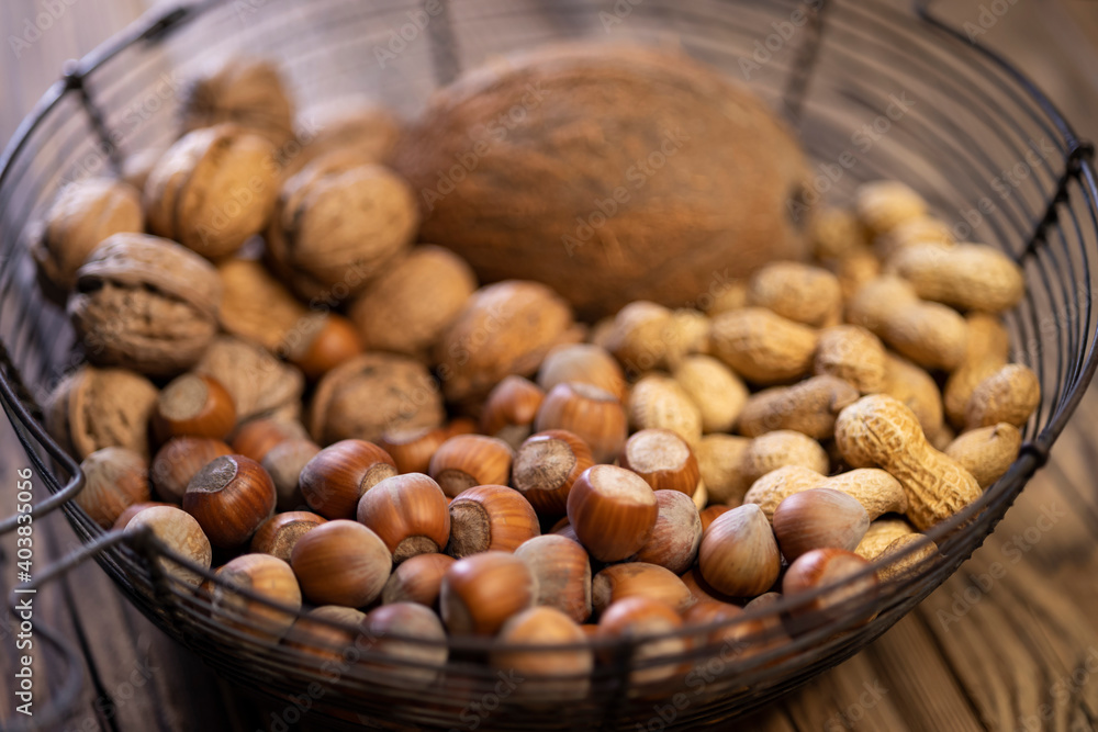 still life with hazelnut peanuts walnut and coconut on wooden board still life with hazelnut peanuts walnut and coconut on wooden board