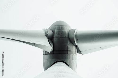 bottom view of wind turbine against sky