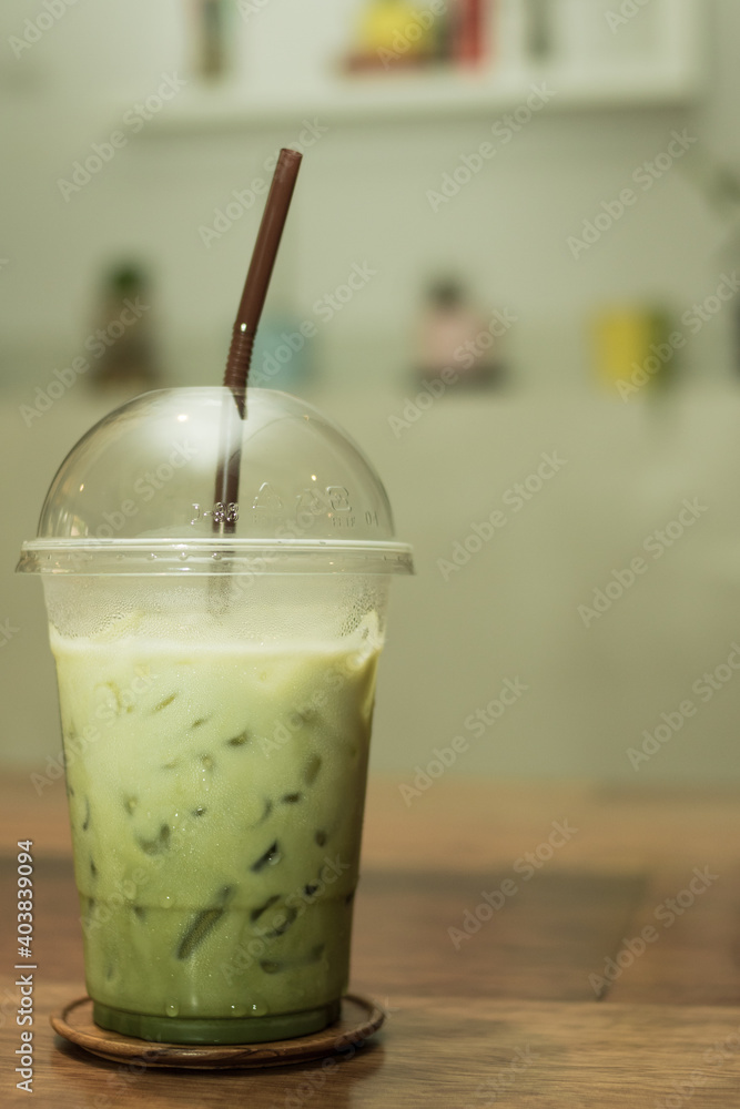 Green tea with fresh milk in a plastic cup..