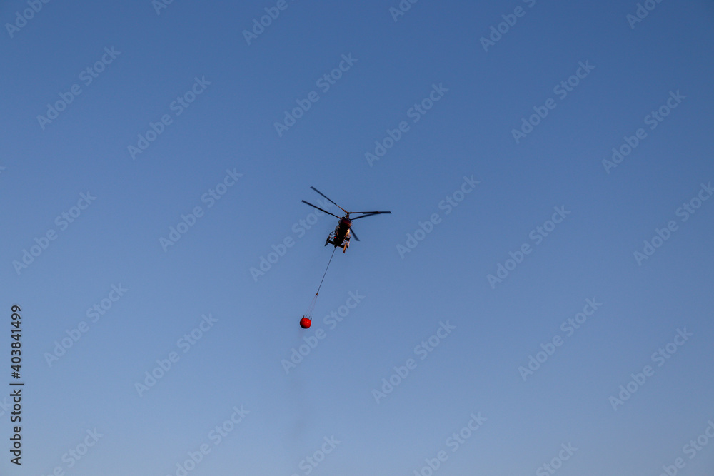helicopter fly over the sky and extinguishes a fire helicopter fly over the sky and extinguishes a fire