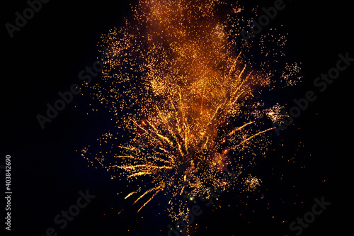 Colorful fireworks isolated on a dark background, close up, copy space. Bright yellow and gold sparks on a dark background. Can be used as a festive background