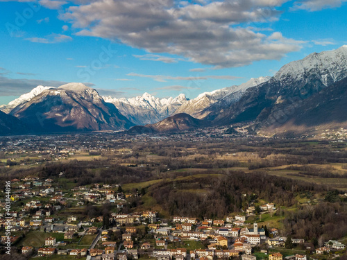 Panoramic from above on the ancient village of San Lorenzo di Buja and on the snow-capped mountains. photo