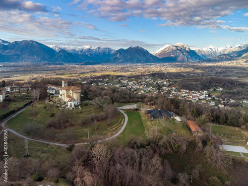 Panoramic from above on the ancient village of San Lorenzo di Buja and on the snow-capped mountains. photo