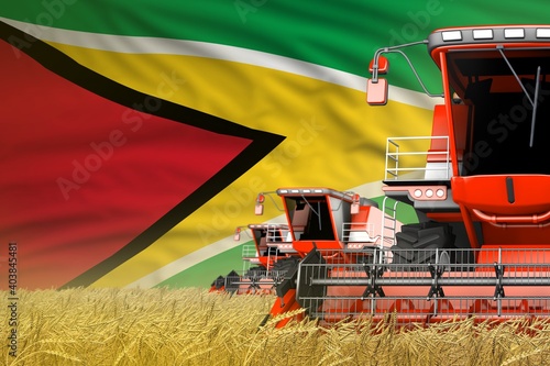 Konstfotografi three red modern combine harvesters with Guyana flag on rye field - close view,