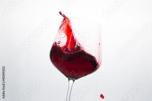 Red wine in a glass on a white background.