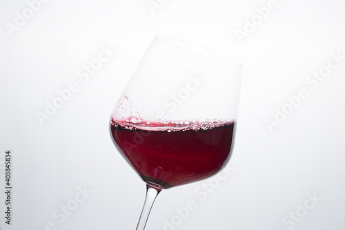 Red wine in a glass on a white background.