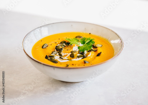 Pumpkin sweet potato lentil cream soup with pumpkin seeds