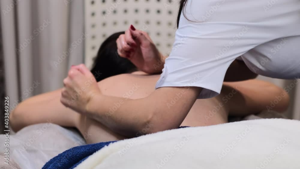 Masseur doing manual massage to client in spa beauty salon using oil Masseur doing manual massage to client in spa beauty salon using oil