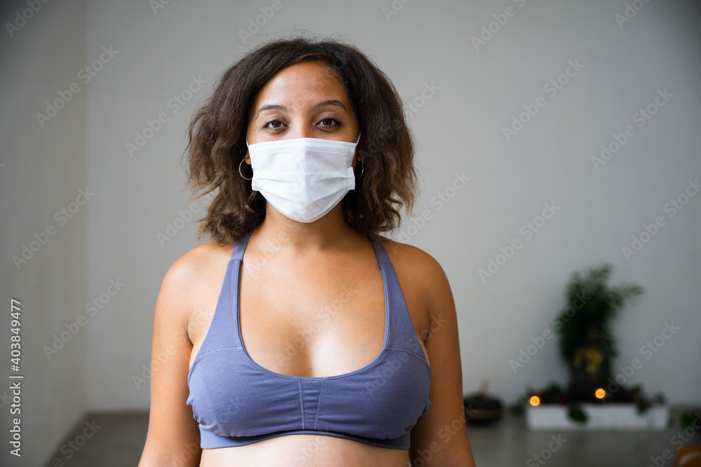 Portrait of beautiful young woman in indoor room - Millennial with face mask for protection from infection by Coronavirus, Covid-19 Portrait of beautiful young woman in indoor room - Millennial with face mask for protection from infection by Coronavirus, Covid-19