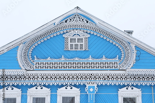 Vintage wooden rural house in Dunilovo village in Ivanovo region, Russia. Building facade; ornamental windows with carved frames. Russian traditional national folk style in architecture. Countryside photo