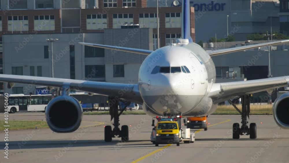 Jet airliner being towed before departure Jet airliner being towed before departure