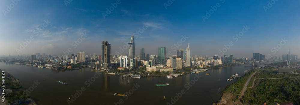 drone panorama of Ho Chi Minh City, Vietnam skyline with view of Saigon River with boats and ships