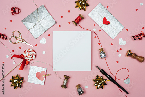 Valentine's Day mock up. White sheet of watercolor paper surrounded by decorations for valentine's day..Gifts, letters and hearts on a pink background.Flat lay with copy space.The concept of love.