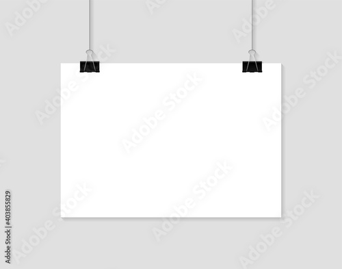 Blank poster hanging on clips. A4 paper page In landscape formats. Realistic white paper sheet. Mockup poster for design.