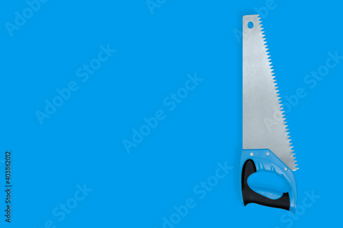 Metal hand saw with a plastic handle on a blue background.