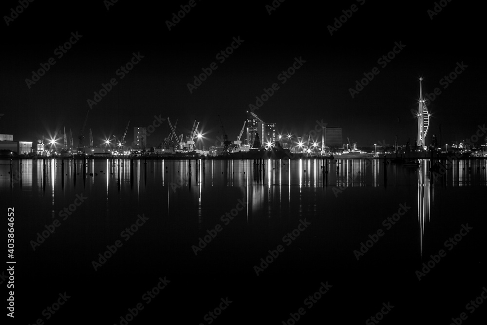 Portsmouth night skyline. Spinnaker Tower in Portsmouth shinning city lights in the night sky.