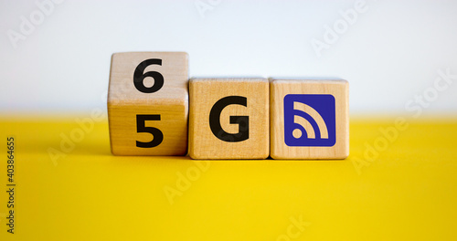 Time to 6G symbol. Turned a wooden cube and changed sign 5G to 6G. Technology, business, network, communication and 6G concept. Beautiful yellow table. White background, copy space.